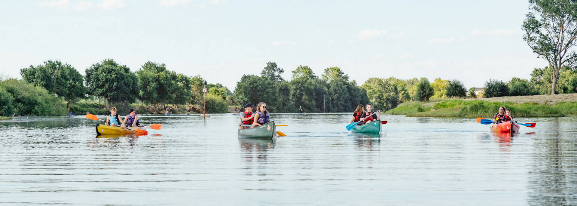 Young people in four canoeing-kayaking