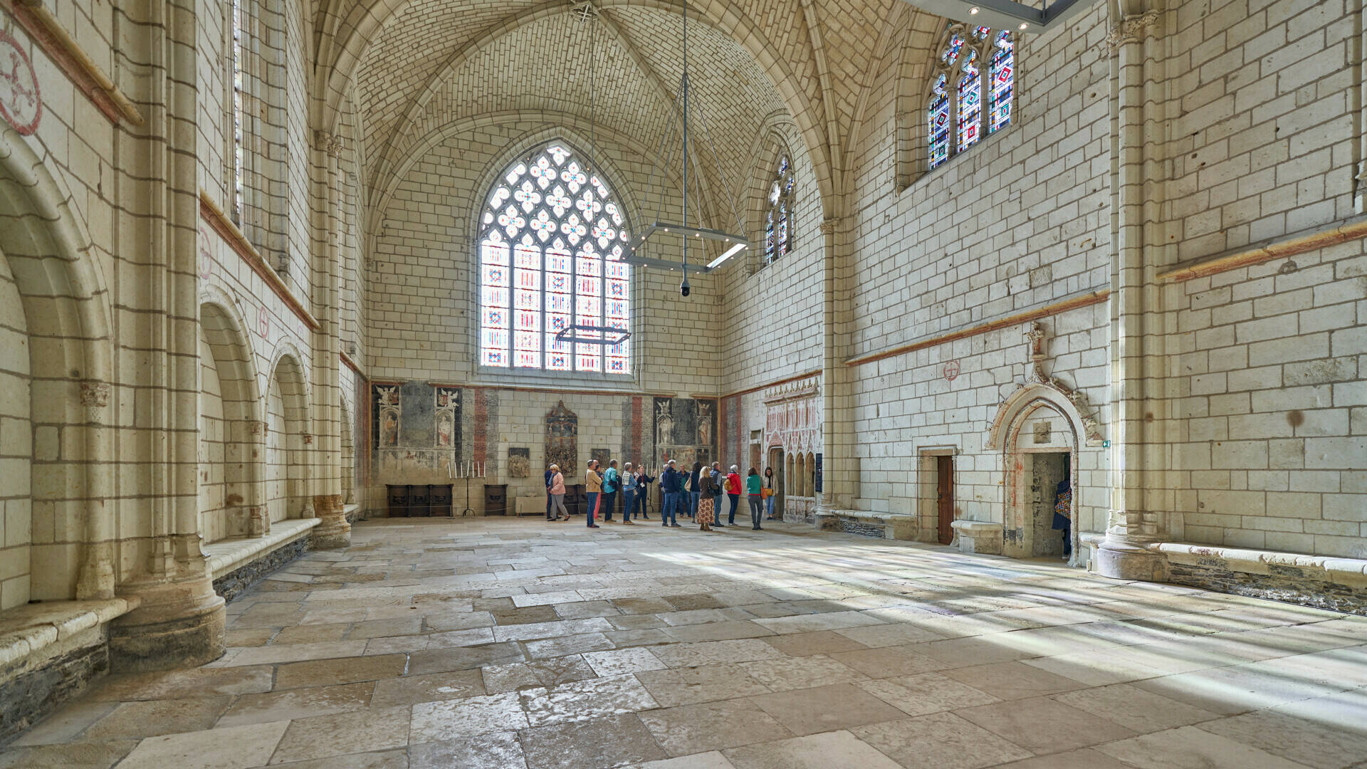 wide shot of the interior of the chapel, a group of visitors in the backround