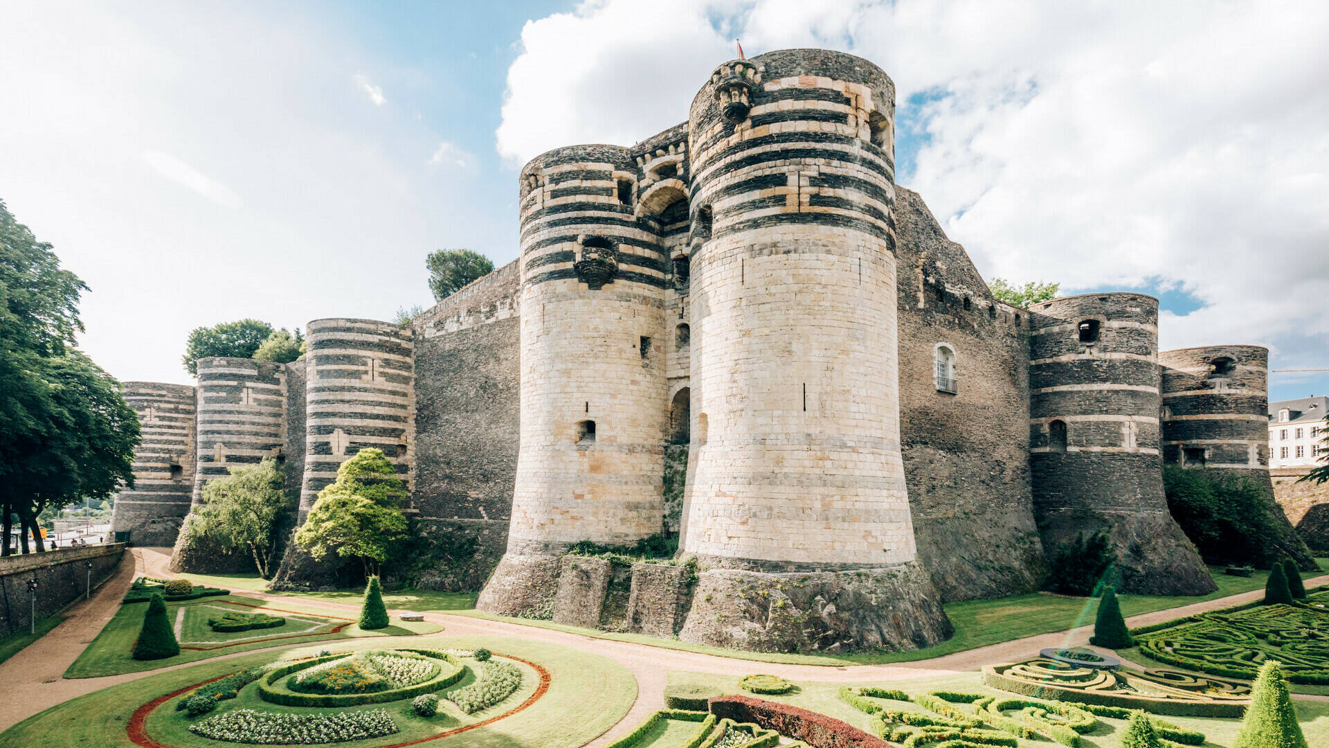 Wide shot of the Château and its gardens at the foot of the building