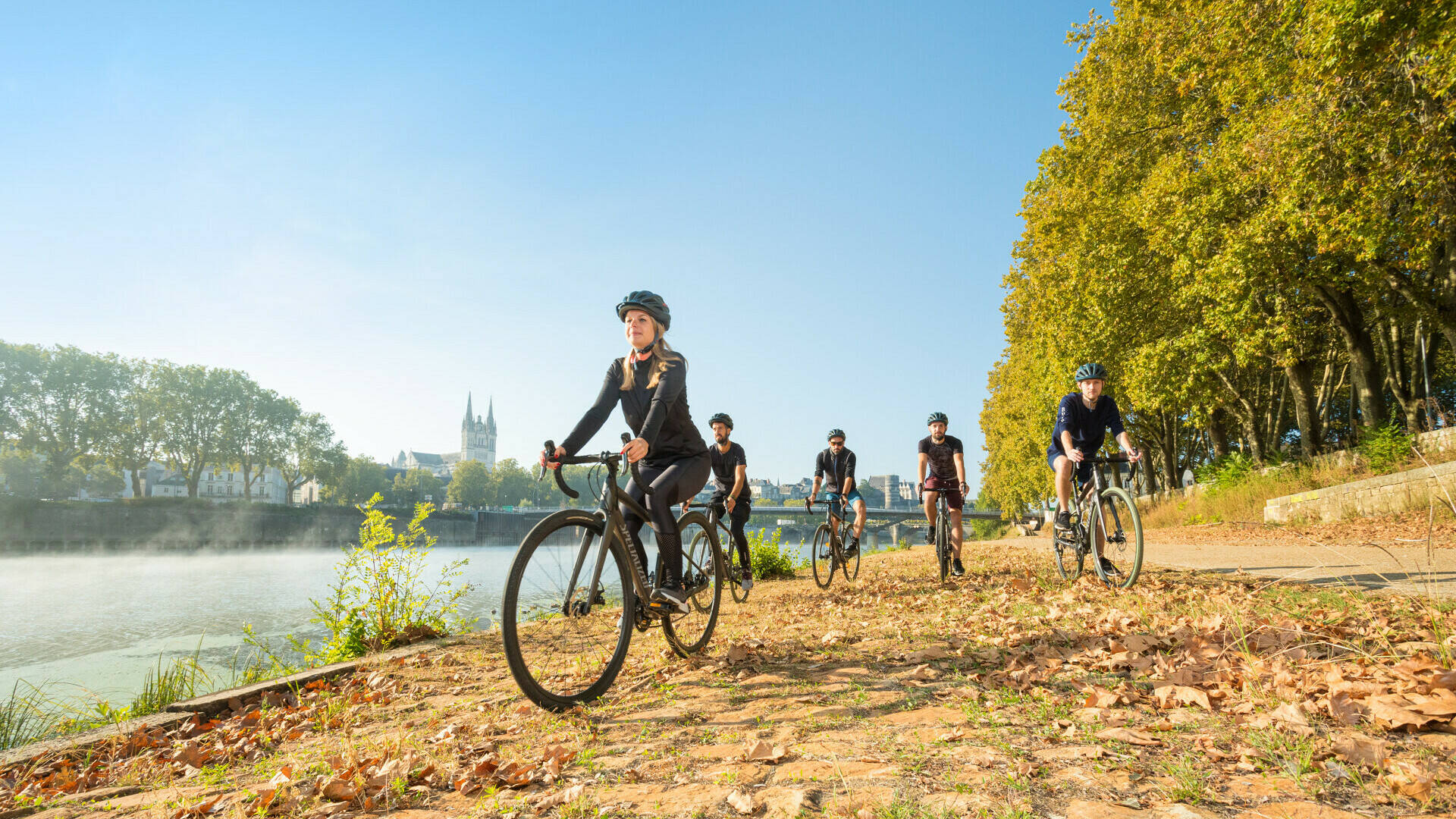 People on gravel bikes along quays of Angers