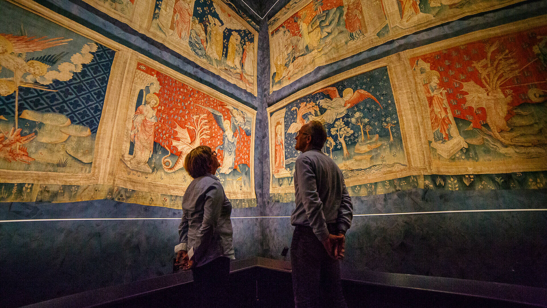 Couple observing the hangings in the gallery