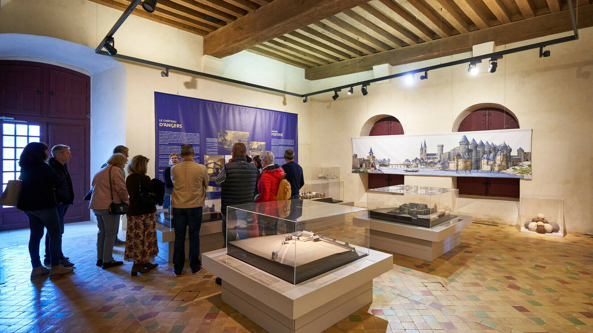Group of visitors in an exhibition room on the history of the Château
