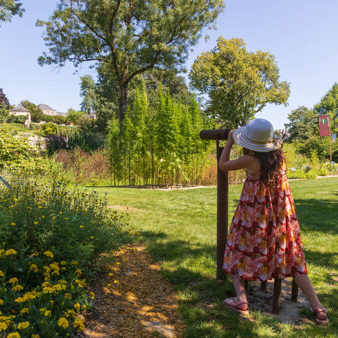 Girl looking at the Camifolia garden in a long view